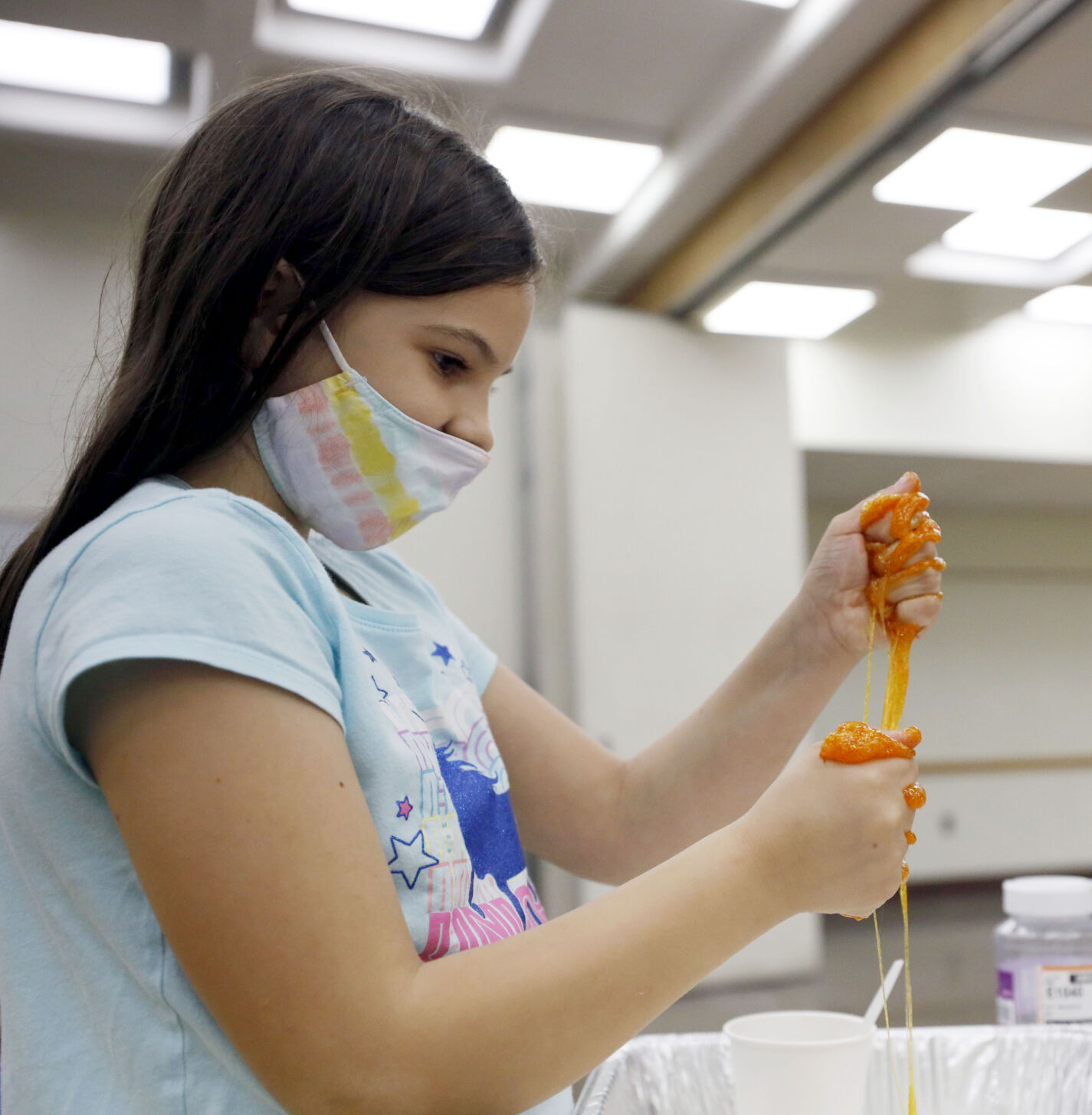 Morgan Faulconer squeezing orange slime in hands